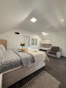a bedroom with a large bed and a couch at Kosmaj Thalia in Babe +66 photos