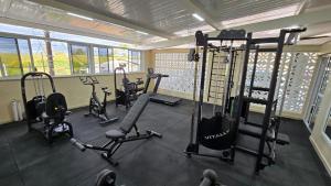 a gym with several exercise equipment in a room at Vincenzo Hotel in São Vicente de Minas