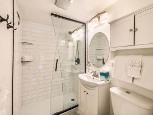 a bathroom with a shower and a toilet and a sink at Edelweiss 12 in Breckenridge +16 photos