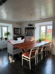 a dining room with a wooden table and chairs at Isomegård Väte Gotland in Klintehamn +45 photos