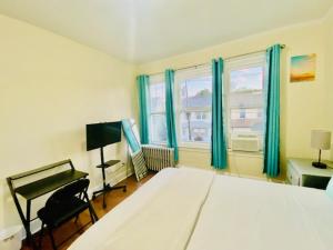 a bedroom with a large white bed and a window at CaneView Properties - 3 in Irvington