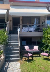 a house with two chairs and a porch with stairs at Sea view Villa Sotiritsa in Velika