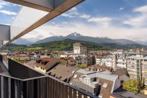 a view of a city with mountains in the background at Radisson RED Innsbruck in Innsbruck