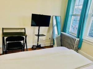 a bedroom with a bed and a desk and a chair at CaneView Properties - 3 in Irvington +8 photos
