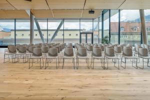 a room with rows of chairs and a podium in a building at Radisson RED Innsbruck in Innsbruck