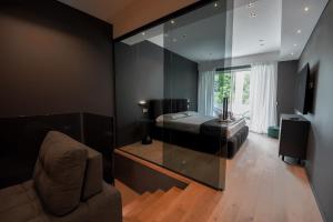 a bedroom with a bed and a glass wall at Roberto Verde House SPECTRE Luxury Suite in Verona
