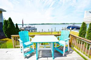 a table and chairs on a deck with a view of the water at Ocean Pines-Harborview Drive 17 home in Ocean Pines
