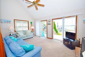 a living room with a blue couch and a tv at Ocean Pines-Harborview Drive 17 home in Ocean Pines