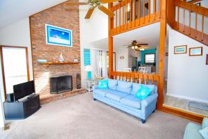 a living room with a blue couch and a fireplace at Ocean Pines-Harborview Drive 17 home in Ocean Pines