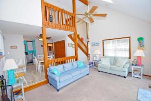 a living room with two couches and a staircase at Ocean Pines-Harborview Drive 17 home in Ocean Pines +15 photos
