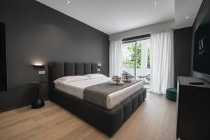 a bedroom with a large bed and a window at Roberto Verde House SPECTRE Luxury Suite in Verona