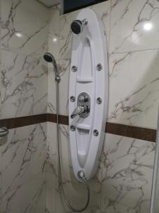 a shower in a bathroom with a shower nozzle at Hotel el sol Caraz in Caraz