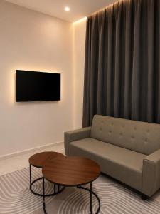 a living room with a couch and a coffee table at Dmana Homestay Arau Perlis in Arau +3 photos