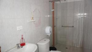 a bathroom with a shower and a toilet and a sink at Hogar de Paso Santa Teresa in Cúcuta