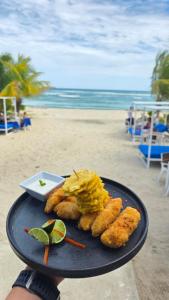 a plate of food on the beach next to the beach at El Tridente in Juan Dolio