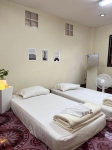 two beds sitting next to each other in a room at The Jetty in Nathon Bay
