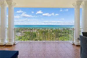 a balcony with a view of the ocean at 3 Villas with Stunning Views & 2 Private Pools in Luquillo