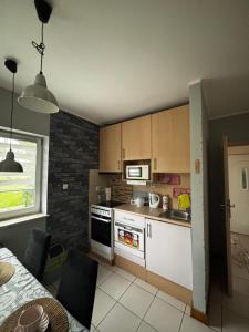 a kitchen with a stove and a sink and a table at Sea House in Puck Free Parking in Puck +11 photos
