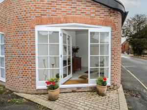 an open door in a brick building with two potted plants at 2 Bed in Southampton