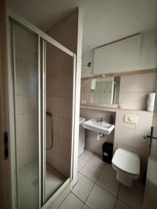 a bathroom with a shower and a toilet and a sink at Sea House in Puck Free Parking in Puck