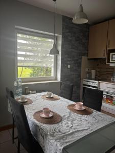 a kitchen with a table with two cups on it at Sea House in Puck Free Parking in Puck