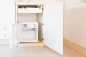 an open door into a small kitchen with a refrigerator at Residence Arco delle Rose in Agropoli