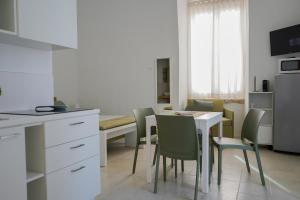 a kitchen and dining room with a table and chairs at C'era una Volta Apartments in Bisceglie