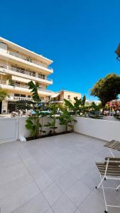 a patio with two chairs and a building at Studio 87 in Rhodes Town