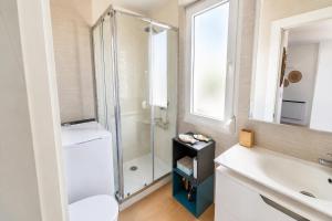 a bathroom with a shower and a toilet and a sink at Brisa de Usil in Mogro