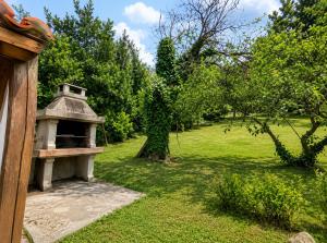 a garden with a bird house in the grass at Airtegal Casa do Puntal in Valdoviño