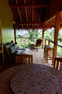 a living room with a couch and a table at Baan Dee Dee in Ko Phayam