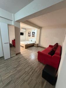 a living room with a red couch in a room at Vila Manila in Eforie Nord