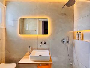 a bathroom with a sink and a mirror at Vaya Zorba Studios in Skiathos +72 photos