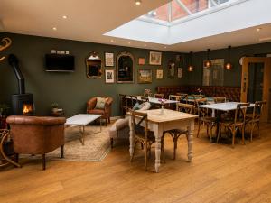 a restaurant with tables and chairs in a room at Stratford Limes Hotel in Stratford-upon-Avon