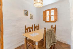 a dining room with a wooden table and chairs at Casa Lola - off grid vakantiehuisje - Puerto Mika in Torviscón +19 photos