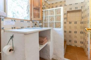 a bathroom with a sink and a toilet paper roll at Casa Lola - off grid vakantiehuisje - Puerto Mika in Torviscón
