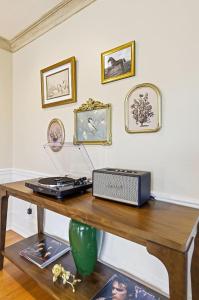 a wooden table with a laptop on top of it at Spacious Proctor Tudor-Sleeps 16-Dog Friendly-Walk in Tacoma +66 photos