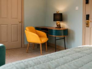a bedroom with a desk and a chair and a bed at Stratford Limes Hotel in Stratford-upon-Avon
