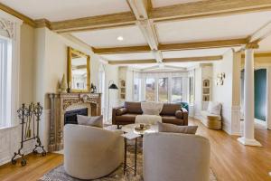 a living room with a couch and a fireplace at Spacious Proctor Tudor-Sleeps 16-Dog Friendly-Walk in Tacoma