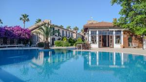 a large swimming pool in front of a building at Aydos Hotels & Breeze Restaurant in Dalyan