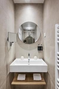 a bathroom with a white sink and a mirror at Nice Excelsior Centre ville by HappyCulture in Nice