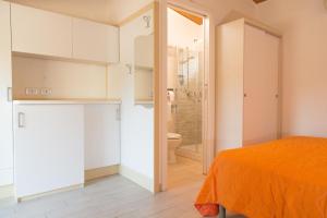 a bedroom with a bed and a bathroom with a shower at Residence Arco delle Rose in Agropoli