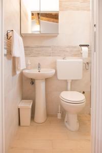 a bathroom with a toilet and a sink at Residence Arco delle Rose in Agropoli