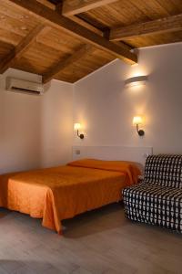 a bedroom with two beds in a room with wooden ceilings at Residence Arco delle Rose in Agropoli +45 photos