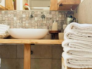 a bathroom with a sink and towels on a counter at Dimora del Capriolo in San Donato Val di Comino