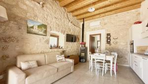 a living room with a couch and a table at Dimora del Capriolo in San Donato Val di Comino
