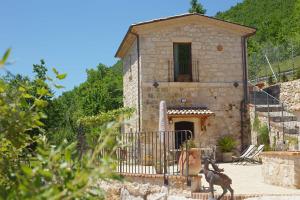a building with a goat standing in front of it at Dimora del Capriolo in San Donato Val di Comino