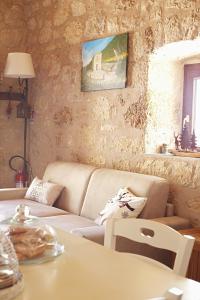 a living room with a couch and a table at Dimora del Capriolo in San Donato Val di Comino +29 photos