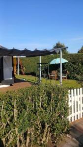 a black canopy over a park with a bench and a playground at Sunny Side at the Sea in Hoek van Holland