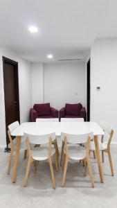 a table and chairs in a room with a couch at Appart Ilyani in El Kseur